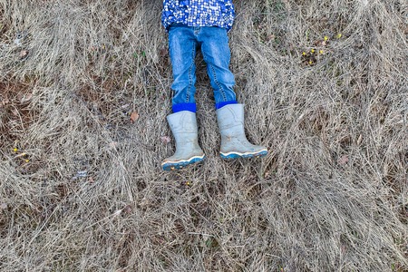 Child lying on the hay.の写真素材
