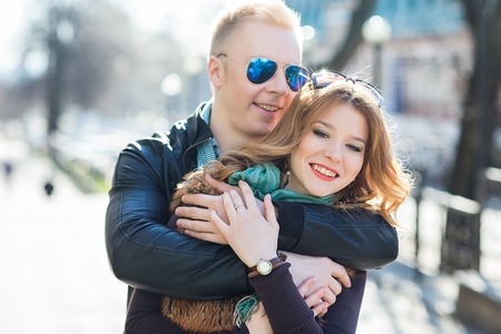 Young couple hugging in the park together.の写真素材