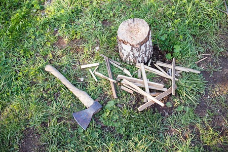 firewood, tree branch on stump with old rusty axeの写真素材
