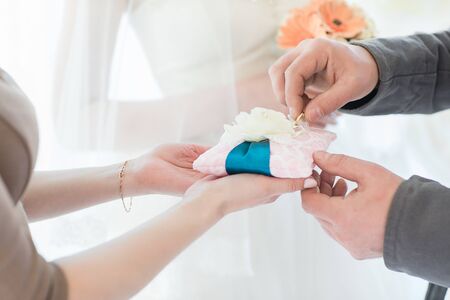 man wears wedding ring on the hand of the womanの写真素材