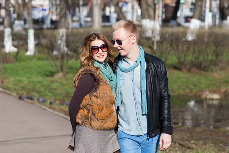 Young couple walking in the park together. lifestyle, people and outdoor concept and ideaの写真素材