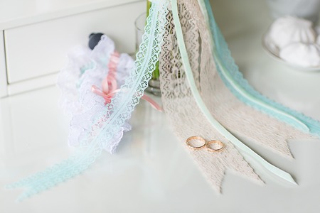 Wedding rings on wedding card, on a white wedding dressの写真素材