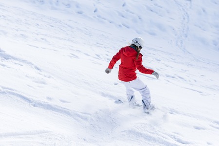 Woman snowboarder on the slopes frosty winter day. Beautiful girl on snoborde in the snow.の写真素材