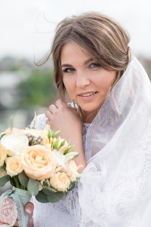 Wedding day. Happy Beautiful young bride outdoorsの写真素材