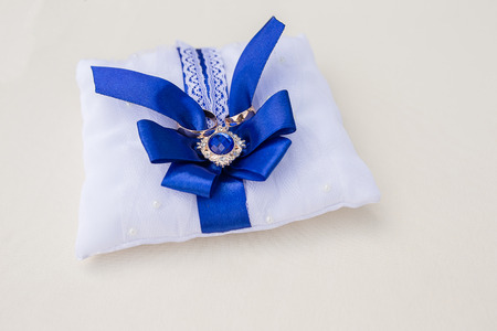 Wedding rings on the lace pillow. Wedding concept.の写真素材