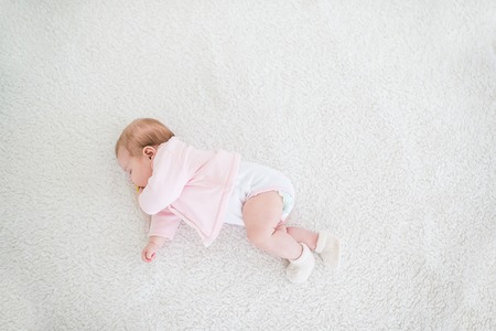 Beautiful baby girl in a pink sleeping sweet dream.