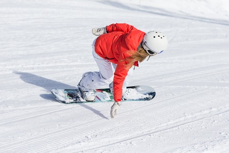 Woman snowboarder on the slopes frosty winter day. Beautiful girl on snoborde in the snow.の写真素材