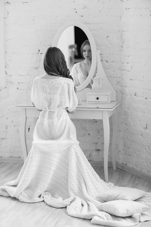 Gentlebride in negligee prepare for the wedding.の写真素材