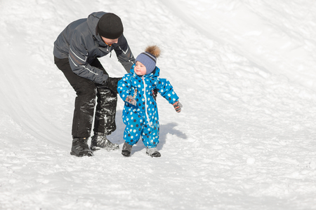 Caring dad walks with his son at weekends in the winter frosty dayの写真素材