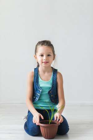 Sweet girl on the floor and the symbol of Earth Dayの写真素材
