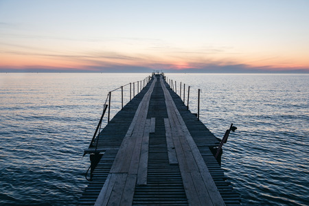 Vacation and Holiday concept - Wooden pier between sunset