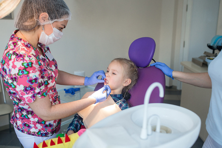 Child as patient with female dentistの写真素材