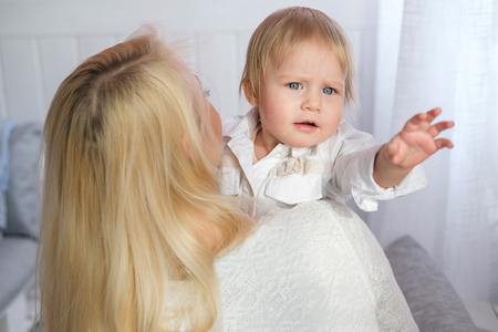 mother playing with her baby in the bedroom.の写真素材