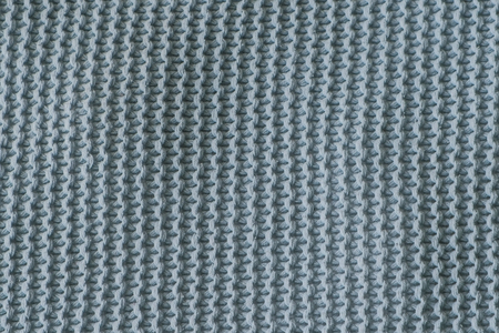 Dark green texture of the knitted fabric Vertical view.