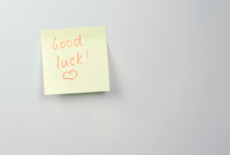 Note on yellow sticker paper sheets with words good luck.の写真素材