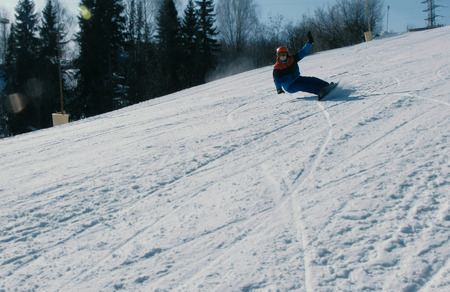 Man slides on a snowboard and ski from snow descent.の写真素材