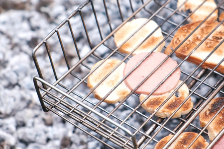Bread and sausage fried on charcoal in the grill.の写真素材