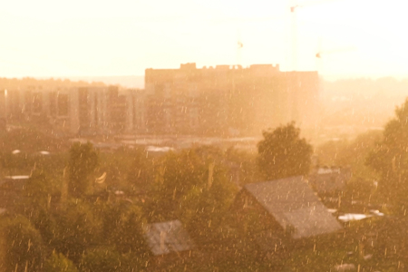 Heavy rain with sun. Beautiful view of the city.