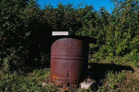 Closed barrel of waste in the suburban area.の写真素材