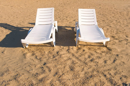 Two sunlongers on the sand beach in summer.の写真素材