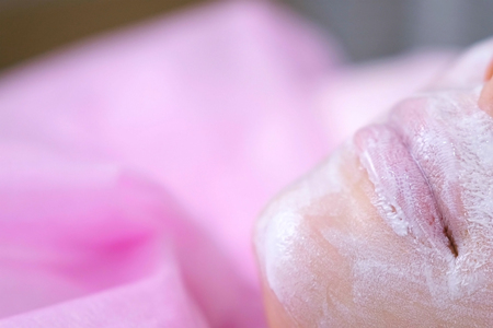 Womans lips and nose with moisturizing mask on the cosmetology procedure. Face close-up.の写真素材