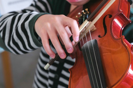 Unrecognizable boy is learning to play violin.の写真素材