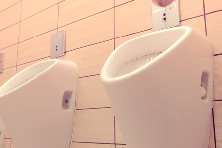 Urinals in men empty public toilet. Close-up view.の写真素材