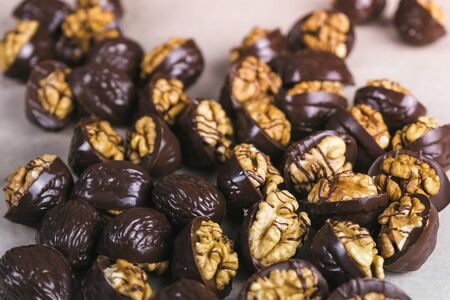 Beautiful tasty chocolates handmade candies with walnuts on bakers paperの写真素材