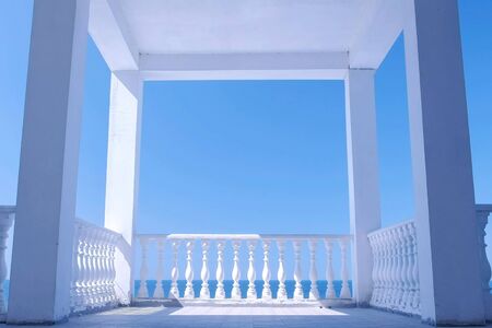 White gazebo on the waterfront with concrete decorative fence and amazing sea view at sunny day.の写真素材