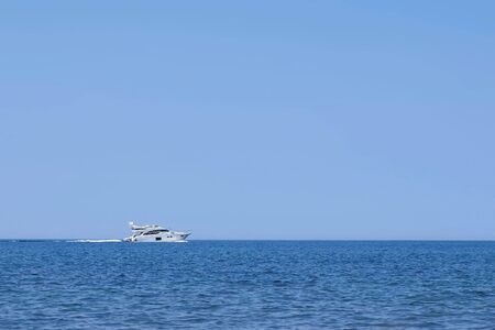 Luxury private yacht racing deep water at sea in vacation, side view. Luxury ship journey. Travel...