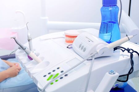 Stomatologist at work in dentistry. Woman dentist uses medical equipment in stomatology clinic for...