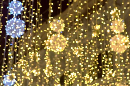 Golden christmas lights beautiful twinkle decorations of street, blur background