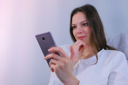Woman watches funny video on mobile phone