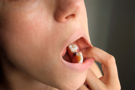 Close-up patient touching dental implant with finger after surgery in dentistry. Metal titanium...