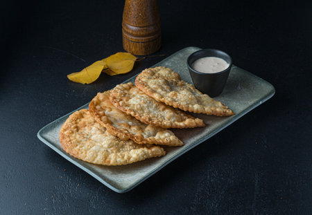 Baked patties with sour cream on a dark background.の写真素材