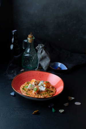Risotto with seafood and green onion, dark background, selective focusの写真素材