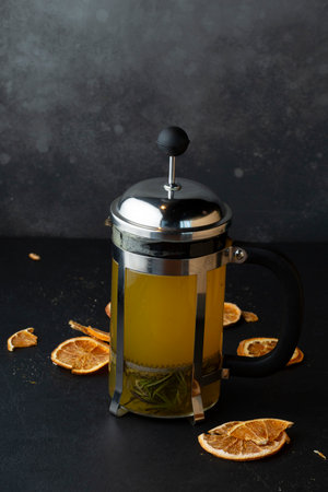 Cup of green tea with lemon and rosemary on dark backgroundの写真素材
