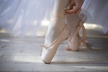 Ballerina putting on pointe shoes, close-up.の写真素材