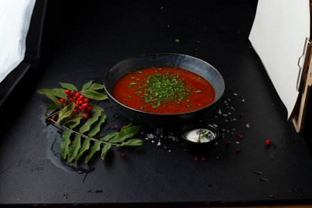 Traditional gazpacho soup in a black bowl on a black backgroundの写真素材