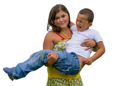 Smiling gypsy child holding little screaming and crying brother kid, isolated on white backgroundの写真素材