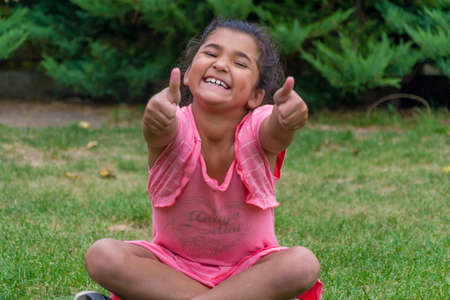 Gypsy girl smiling and gesticulating excelenceの写真素材