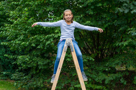 Young child girl play on relays, fly like a birdの写真素材