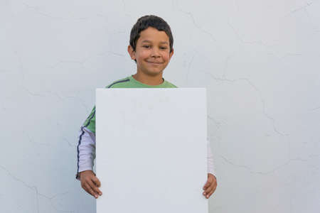 Smiling gypsy child boy holding white bannerの写真素材