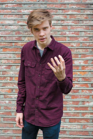 Teenage boy expressing his arguments gesticulatingの写真素材