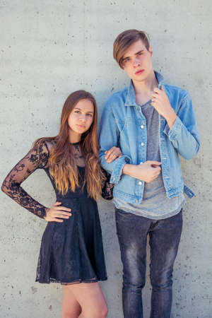 Teenage couple on a date posing over urban background, filter photoの写真素材
