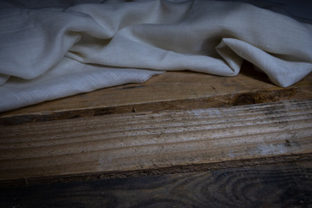 White fabric on a wooden background. Selective focus. Toned.の写真素材