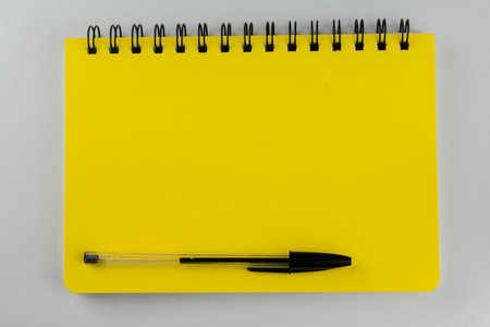 Notebook and pen isolated on white background. Top view with copy spaceの写真素材