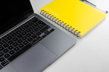Laptop, notebook and pen on white background, business concept.の写真素材
