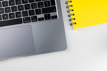 Laptop and notepad on a white background. View from aboveの写真素材
