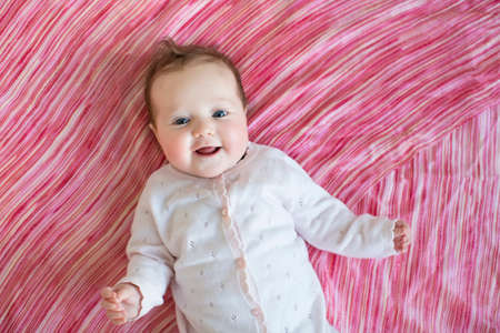 Baby on pink sheetの写真素材